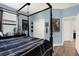 Charming bedroom with a four-poster bed, complemented by blue walls and unique themed decorations at 679 Challice Dr, Spring Hill, FL 34609