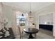 Bright dining area with chandelier next to a room with blue bedspread seen through the arch at 679 Challice Dr, Spring Hill, FL 34609