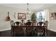 Elegant dining room features a large wooden table, stylish chairs, and ample natural light creating inviting space at 679 Challice Dr, Spring Hill, FL 34609
