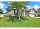 A charming home featuring landscaped garden beds and well manicured lawn at 679 Challice Dr, Spring Hill, FL 34609