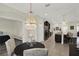Open-concept kitchen with granite counters, stainless appliances, and island seating flows into dining area offering versatile layout at 679 Challice Dr, Spring Hill, FL 34609