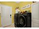 Modern laundry room featuring a side-by-side washer and dryer with decor and signage at 679 Challice Dr, Spring Hill, FL 34609
