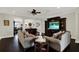 Spacious living room featuring dark wood flooring, archways, and a built-in entertainment center at 679 Challice Dr, Spring Hill, FL 34609