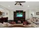 Comfortable living room with neutral tones, ceiling fan, and built-in entertainment center at 679 Challice Dr, Spring Hill, FL 34609
