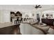 Open-concept living room features dark hardwood floors, elegant decor, and seamless flow to the kitchen area at 679 Challice Dr, Spring Hill, FL 34609