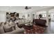 Open-concept living room with dark wood flooring seamlessly connecting the kitchen and dining areas at 679 Challice Dr, Spring Hill, FL 34609