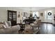 Inviting living room with a dark wood floors, large windows, and elegant furnishings at 679 Challice Dr, Spring Hill, FL 34609