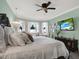 Large main bedroom with a luxurious bed and attached sitting area with a beach view on TV at 679 Challice Dr, Spring Hill, FL 34609