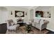Inviting sitting area boasts tufted furnishings, stylish decor, and a cozy ambiance for relaxation and conversation at 679 Challice Dr, Spring Hill, FL 34609