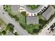 An aerial view of a home with a well-manicured lawn and a driveway on a tree-lined street at 6940 47Th N Way, Pinellas Park, FL 33781