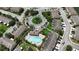 Aerial view of community featuring a blue pool, lush landscaping, and convenient parking at 6940 47Th N Way, Pinellas Park, FL 33781