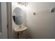 Powder room featuring a pedestal sink, oval mirror, and updated fixtures at 6940 47Th N Way, Pinellas Park, FL 33781