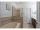 Main bathroom with a tub, tiled shower, and vanity with generous counter space at 6940 47Th N Way, Pinellas Park, FL 33781