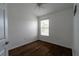 Bedroom featuring wood floors, one window with blinds, and ceiling fan with light at 6940 47Th N Way, Pinellas Park, FL 33781