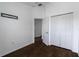 This minimalist bedroom features wood floors, closet space and a TV mount at 6940 47Th N Way, Pinellas Park, FL 33781