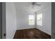 Comfortable bedroom with hardwood floors, bright windows, and a classic ceiling fan at 6940 47Th N Way, Pinellas Park, FL 33781