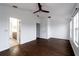Bright main bedroom boasts hardwood floors, a ceiling fan, and access to an ensuite bathroom at 6940 47Th N Way, Pinellas Park, FL 33781