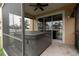Screened-in patio area with a hot tub and view of the surrounding landscape at 6940 47Th N Way, Pinellas Park, FL 33781