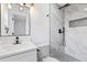 Updated bathroom featuring a new vanity, mirror, and luxurious tile shower at 8009 Somerset Ln, Tampa, FL 33615
