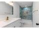 Modern bathroom with a marble tiled shower/tub combo, gold fixtures, and a white vanity at 8009 Somerset Ln, Tampa, FL 33615