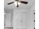 Bedroom featuring light floors, a ceiling fan, and a sliding closet at 8009 Somerset Ln, Tampa, FL 33615