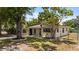 Charming single-story home featuring a freshly landscaped front yard and neutral color scheme at 8009 Somerset Ln, Tampa, FL 33615