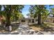 Inviting home with a quaint front yard, mature shade trees, and a paved walkway to the front door at 8009 Somerset Ln, Tampa, FL 33615