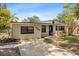 Single story home featuring updated paint, well-manicured landscaping, and a concrete driveway at 8009 Somerset Ln, Tampa, FL 33615