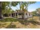 Single story home featuring an updated yard, new landscaping, and a chain-link fence at 8009 Somerset Ln, Tampa, FL 33615