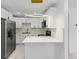 Contemporary kitchen with stainless steel fridge, bright counters, and modern appliances at 8009 Somerset Ln, Tampa, FL 33615