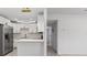 Bright, modern kitchen featuring stainless steel appliances and stylish light fixtures at 8009 Somerset Ln, Tampa, FL 33615