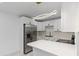 Modern kitchen with stainless steel appliances, white cabinets, and quartz countertops at 8009 Somerset Ln, Tampa, FL 33615