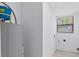 Bright laundry room featuring a window and in-unit water heater at 8009 Somerset Ln, Tampa, FL 33615