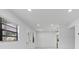 Bright living room featuring updated paint, flooring, and recessed lighting at 8009 Somerset Ln, Tampa, FL 33615
