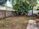 View of backyard featuring a wood fence, mature tree and shed on property at 8313 Arabian Dunes Pl, Riverview, FL 33578