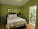 Bedroom with a double bed, leading to a bathroom through an open doorway at 8313 Arabian Dunes Pl, Riverview, FL 33578
