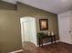 Inviting hallway with tiled flooring and decorative console table at 8313 Arabian Dunes Pl, Riverview, FL 33578