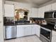 Bright kitchen featuring modern stainless steel appliances and white cabinets at 8313 Arabian Dunes Pl, Riverview, FL 33578
