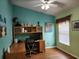 Home office with built-in desk, wood floors, and an abundance of natural light at 8313 Arabian Dunes Pl, Riverview, FL 33578