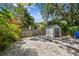 Backyard featuring a shed, partial gravel cover, lush landscaping, and fencing for privacy at 848 9Th S Ave, St Petersburg, FL 33701