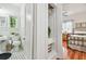 Bathroom showcasing a black and white tiled floor and a nearby bedroom with an adjacent linen closet at 848 9Th S Ave, St Petersburg, FL 33701