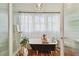 Elegant bathroom with a classic clawfoot tub, crystal chandelier, and soft, sheer curtains for privacy at 848 9Th S Ave, St Petersburg, FL 33701