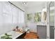 Charming bathroom with vintage clawfoot tub, sheer curtains, and stylish gray vanity for a modern touch at 848 9Th S Ave, St Petersburg, FL 33701