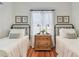 Charming bedroom featuring twin beds, hardwood floors, and a wooden nightstand with lamps at 848 9Th S Ave, St Petersburg, FL 33701