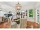The dining room flows into the living area with hardwood floors, windows, and stylish furnishings at 848 9Th S Ave, St Petersburg, FL 33701