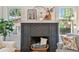 Close up of the black brick fireplace and mantel, with windows on either side for natural lighting at 848 9Th S Ave, St Petersburg, FL 33701