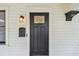 A close-up of a stylish front door with a classic design and modern security features at 848 9Th S Ave, St Petersburg, FL 33701