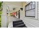 Charming covered front porch with a swing and unique checkered flooring for added character at 848 9Th S Ave, St Petersburg, FL 33701
