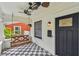 Cozy covered front porch featuring a porch swing, unique flooring, and ceiling fans at 848 9Th S Ave, St Petersburg, FL 33701