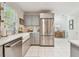Bright kitchen features stainless steel appliances, subway tile backsplash, and gray cabinetry at 848 9Th S Ave, St Petersburg, FL 33701
